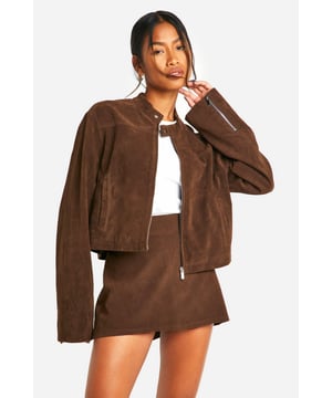 Faux suede jacket with zip-up front for easy wear
        Collarless design with a sleek, modern silhouette
        Long sleeves for versatile styling options
        Side pockets for practicality and hand warmth
        Cropped length perfect for pairing with high-waisted bottoms
    
    This faux suede jacket is a must-have addition to your casual wardrobe. Its soft texture and rich appearance lend a touch of luxury to any outfit, whilst maintaining a relaxed vibe. The zip-up front allows for effortless styling, whether fully fastened for a polished look or left open for a more laid-back feel. Pair it with a crisp white top and a matching mini skirt for a coordinated ensemble that's perfect for brunch with friends or a day of shopping. For a more casual approach, team it with your favourite jeans and trainers. The versatility of this jacket makes it ideal for family gatherings or casual outings. Its cropped length works wonderfully with high-waisted trousers or skirts, creating a balanced silhouette. Accessorise with statement earrings and a crossbody bag to complete your look. This Boohoo jacket embodies the brand's ethos of providing trendy, inclusive fashion that doesn't compromise on style or value.