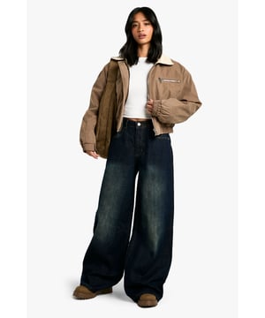 Wide-leg silhouette for a relaxed, on-trend look
        High-rise waist for a flattering fit
        Classic five-pocket design
        Contrast stitching for added visual interest
        Versatile denim fabric suitable for various casual occasions
    
    Make a bold statement with these petite wide-leg jeans from Boohoo. Perfect for the fashion-forward woman who values both style and comfort, these jeans offer a contemporary twist on a classic wardrobe staple. The high-rise waist creates a sleek silhouette, while the wide-leg cut adds a touch of drama to your ensemble. Style these jeans with a cropped white top and chunky trainers for a casual daytime look that's sure to turn heads. For a more polished appearance, pair them with a fitted blouse and heeled boots. These versatile jeans are ideal for various casual events, from weekend brunches to family gatherings. The denim fabric ensures durability and ease of care, making these jeans a practical choice for your everyday wardrobe. Embrace the latest trends and showcase your unique style with these must-have wide-leg jeans.