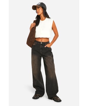 Wide-leg silhouette for a relaxed, on-trend look
        Raw hem detail adds an edgy, unfinished touch
        High-rise waist for a flattering fit
        Classic five-pocket styling for practicality
        Versatile denim fabric suitable for various casual occasions
    
    Make a bold statement with these petite wide-leg jeans, perfect for the fashion-forward woman who loves to stay ahead of the trends. The baggy fit offers supreme comfort without compromising on style, while the raw hem adds a touch of rebellious charm to your ensemble. Pair these jeans with a cropped top and trainers for a laid-back daytime look, or dress them up with a fitted blouse and heeled boots for a night out with friends. The high-rise waist not only flatters your figure but also provides ample styling options - tuck in a graphic tee for a casual vibe or add a belt to accentuate your waistline. Ideal for family gatherings, weekend brunches, or casual outings, these jeans offer the perfect blend of comfort and style for the modern, trend-conscious woman.