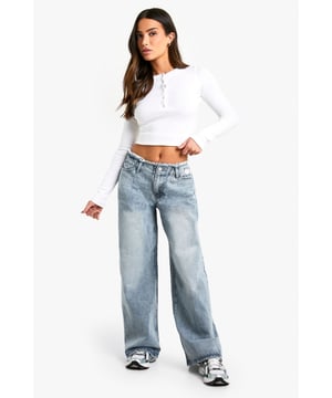 Wide leg design for a relaxed, on-trend silhouette
        High-rise waist with frayed edge detailing
        Classic five-pocket styling for practicality
        Light wash denim for a versatile, casual look
        Ankle-grazing length perfect for showcasing footwear
    
    Make a bold statement with these eye-catching wide leg jeans from Boohoo's petite range. The frayed waistband adds a touch of edgy charm, while the relaxed fit ensures all-day comfort without compromising on style. Perfect for the fashion-forward woman who values both trends and comfort, these jeans can effortlessly transition from day to night. Pair them with a cropped top and trainers for a casual daytime look, or dress them up with a fitted bodysuit and heeled boots for an evening out. The versatile light wash makes these jeans a wardrobe staple, easily matched with a variety of tops and accessories. Whether you're heading to a family gathering or meeting friends for a coffee, these jeans will keep you looking chic and feeling confident.