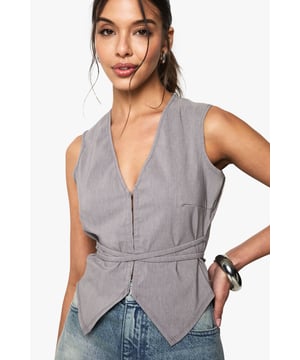 Sleek waistcoat design with hook and eye closure
        Plunging V-neckline for a daring look
        Belted waist detail for a flattering silhouette
        Versatile sleeveless style perfect for layering
        Textured bengaline fabric adds visual interest
    
    Make a statement on your next night out with this chic melange waistcoat. The plunging neckline and fitted silhouette create a bold, confident look that's sure to turn heads. Style it with high-waisted jeans and strappy heels for a trendy bar-hopping ensemble, or pair it with tailored trousers and stilettos for a more upscale cocktail affair. The versatile design allows for endless styling options - layer it over a sheer blouse for added intrigue, or wear it solo to showcase the eye-catching hook and eye closure. The belted waist detail cinches you in at just the right spot, creating a figure-flattering shape that works for a variety of body types. Whether you're dancing the night away or enjoying drinks with friends, this waistcoat is the perfect piece to express your fashion-forward style and make a lasting impression.