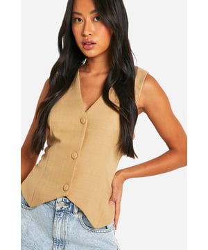Textured woven crepe fabric for added visual interest
        Sleeveless design with a collared neckline
        Button-front closure for easy wear
        Relaxed fit for comfortable, effortless style
        Charming bow-tie detail at the back for a feminine touch
    
    This structured woven vest from Boohoo is a versatile piece that can effortlessly transition from day to night. The relaxed fit and textured crepe fabric create a laid-back yet polished look, perfect for various casual occasions. Style it with denim shorts and trainers for a chic daytime ensemble, or pair it with tailored trousers and heels for a more sophisticated evening outfit. The button-front closure allows for customisable styling, while the unexpected bow-tie detail at the back adds a playful twist. Ideal for family gatherings, brunches with friends, or casual Fridays at the office, this vest is a must-have addition to your wardrobe. Its adaptable nature makes it suitable for layering in cooler weather or wearing on its own during warmer months, ensuring year-round wearability.