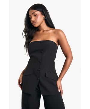 Sleek bandeau neckline for a chic, strapless look
        Structured woven crepe fabric with slight stretch for comfort
        Button-front detail adds a tailored touch
        Flap pockets at the waist for a utilitarian twist
        Versatile long-line silhouette pairs perfectly with trousers
    
    Make a statement in this striking bandeau vest that seamlessly blends sophistication with edge. The long-line silhouette creates a flattering, elongated look, while the button-front detail and flap pockets add a touch of tailored refinement. Perfect for those who love to push fashion boundaries, this piece can be styled for various occasions. For a casual daytime ensemble, pair it with high-waisted wide-leg trousers and trainers. Dress it up for evening drinks by adding statement earrings and strappy heels. The versatile design allows for endless styling possibilities, making it a must-have addition to any fashion-forward wardrobe. Whether you're heading to a family gathering or meeting friends for a casual brunch, this bandeau vest will ensure you stand out with effortless style.