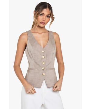 Tailored waistcoat featuring distinctive wooden buttons for a natural touch
        Sleek V-neckline creates an elegant silhouette perfect for layering
        Contoured fit with subtle waist definition for a flattering shape
        Versatile sleeveless design ideal for year-round styling
        Woven fabric with slight stretch ensures comfort throughout the day
    
    This sophisticated waistcoat brings tailored refinement to any ensemble. The wooden button detailing adds a distinctive character to this otherwise classic piece, making it perfect for occasions that demand polished style. Pair with crisp white wide-leg trousers as shown for a contemporary take on formal dressing, or layer over a fitted blouse for added dimension. For summer events, style with a printed neck scarf and statement accessories for a fashion-forward look. The versatile design transitions seamlessly from office to evening, making it an essential wardrobe investment. For formal occasions such as graduations or race days, complement with tailored trousers and delicate jewellery for an ensemble that conveys understated elegance. The structured silhouette creates a refined look whilst maintaining comfort for all-day wear.