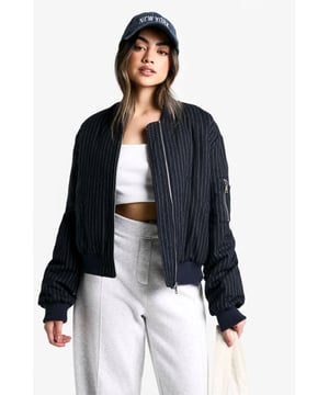 Chic pinstripe pattern for a sophisticated twist on casual wear
        Bomber-style silhouette with ribbed collar, cuffs, and hem
        Roomy sleeves for comfortable layering
        Convenient side zip pocket for essentials
        Versatile zip-front closure for easy wear
    
    Embrace the fusion of smart and casual with this pinstripe bomber jacket in wool-look fabric. Perfect for the fashion-forward woman who loves to mix up her style, this piece offers endless versatility. Pair it with wide-leg trousers and trainers for a laid-back yet put-together look, ideal for weekend brunches or casual Fridays at the office. For a night out with friends, throw it over a crop top and high-waisted jeans, adding some statement earrings for extra flair. The jacket's relaxed fit allows for easy layering over jumpers when the temperature drops, making it a year-round staple. Whether you're running errands or meeting mates for a quick coffee, this bomber will keep you looking effortlessly cool and feeling comfortably chic.
