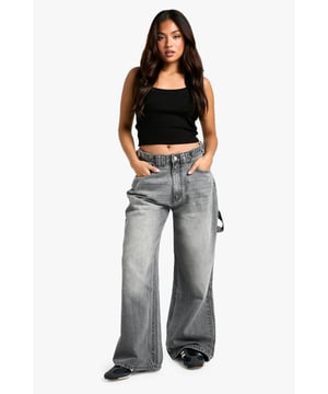 Wide-leg silhouette for a trendy, relaxed fit
        High-rise waist with belt loops for versatile styling
        Spacious side pockets and back pockets for practicality
        Durable cotton fabric for long-lasting wear
        Petite-friendly length, perfect for shorter frames
    
    Make a bold statement with these eye-catching wide-leg jeans from Boohoo's petite collection. Designed to flatter shorter frames, these trousers offer a perfect blend of comfort and style. The high-rise waist cinches you in at your smallest point, while the relaxed wide-leg cut creates a fashionable silhouette that's bang on trend. Style these versatile jeans with a cropped top and oversized jacket for a casual daytime look, or dress them up with a fitted bodysuit and heeled boots for a night out with friends. The durable cotton fabric ensures these jeans will be a wardrobe staple for seasons to come, making them ideal for everything from family gatherings to casual Fridays at the office. Embrace the latest fashion trends and showcase your unique style with these must-have petite jeans.