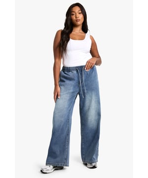 Straight-leg denim jeans with elastic waistband for comfort
        Wide-leg silhouette for a relaxed, on-trend look
        High-rise fit to flatter curves and provide coverage
        Adjustable drawstring for a customisable fit
        Versatile medium wash suitable for various casual occasions
    
    Embrace laid-back chic with these plus-size straight-leg jeans from Boohoo. The elastic waistband and adjustable drawstring offer unparalleled comfort and a personalised fit, perfect for all-day wear. The wide-leg silhouette creates a trendy, relaxed look that's ideal for casual outings. Style these jeans with a fitted white vest top and an oversized denim jacket for an effortlessly cool double denim ensemble. Add a pair of chunky trainers for a street-style edge, or dress them up with block-heel sandals for a casual night out. These versatile jeans are a wardrobe essential, easily transitioning from daytime errands to relaxed evening gatherings with friends. The high-rise fit and straight leg combine to create a flattering silhouette that complements curves beautifully, making these jeans a go-to choice for the fashion-forward woman who values both style and comfort.