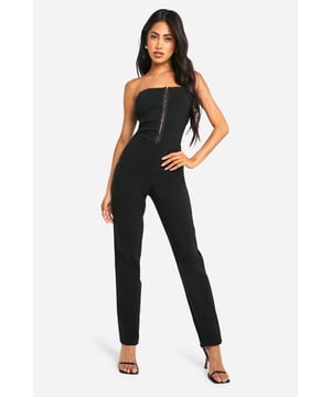 Sleek bandeau neckline for a chic, strapless look
        Figure-hugging korsett-style bodice accentuates curves
        Full-length jumpsuit with a streamlined silhouette
        Front zip detail adds an edgy, contemporary touch
        Versatile design suitable for various evening occasions
    
    Make a bold statement in this striking Bandeau Korsett-Jumpsuit from Boohoo. Perfect for the fashion-forward woman who loves to turn heads, this all-in-one piece combines sleek sophistication with daring design. The bandeau neckline and korsett-style bodice create a flattering silhouette, while the full-length trousers elongate your frame for a statuesque look. Ideal for nights out on the town, this jumpsuit can be styled with strappy heels and statement earrings for a glamorous ensemble. Layer with a tailored blazer for added versatility, taking you from cocktail hour to dance floor with effortless style. Whether you're meeting friends at a trendy bar or hitting the club scene, this jumpsuit is your go-to for making an unforgettable impression.