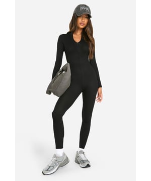 Ribbed texture for a flattering fit
        Zip-up front for easy wear and adjustable coverage
        Collared neckline adds a sophisticated touch
        Skinny fit accentuates your silhouette
        Long sleeves for versatile styling options
    
    This Basic Ribbed Zip Up Skinny Jumpsuit from Boohoo is the ultimate wardrobe staple for the fashion-forward woman. Perfect for casual outings or relaxed gatherings, this all-in-one piece offers both comfort and style. The ribbed texture hugs your curves in all the right places, while the zip-up front allows you to customise your look. Style it with trainers and a cap for a laid-back daytime ensemble, or dress it up with heeled boots and statement earrings for an evening out with friends. Layer with an oversized denim jacket or a longline cardigan for cooler days. This versatile jumpsuit transitions effortlessly from coffee dates to family barbecues, making it an essential piece for your everyday wardrobe. Its simplicity makes it an ideal canvas for accessorising, so don't hesitate to experiment with bold jewellery or a statement belt to create your unique look.