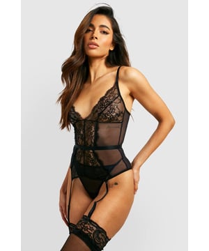 Intricate lace detailing for a romantic touch
        Sheer mesh panels create a sultry silhouette
        Adjustable shoulder straps for a customised fit
        Suspender straps add a classic lingerie element
        Matching thong included for a coordinated set
    
    Indulge in the allure of this captivating lace suspender basque and thong set from Boohoo. The delicate lace fabric intertwines with sheer mesh panels to create a tantalising play of reveal and conceal. The basque features a plunging neckline and a figure-hugging design that accentuates your curves. Adjustable shoulder straps ensure a perfect fit, while the suspender straps add a touch of vintage glamour. The included matching thong completes the ensemble, offering a coordinated look from top to bottom. This set is ideal for those moments when you want to feel confident and sensual in your own skin. Whether it's for a special occasion or simply to treat yourself, this lingerie set is sure to make you feel like the belle of the boudoir.