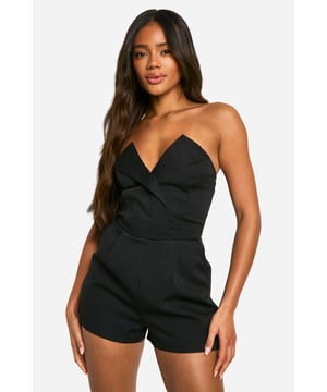 Sleek bandeau neckline for a chic, strapless look
        Flattering wrap-style bodice with a plunging V-neck
        Figure-hugging silhouette to accentuate curves
        Short length perfect for showcasing legs
        Versatile design suitable for various night-out occasions
    
    Make a statement on your next night out with this alluring bandeau playsuit from Boohoo. The wrap-style bodice creates a sultry plunging neckline, while the strapless design shows off your shoulders for a flirtatious touch. Perfect for those balmy summer evenings or heated dance floors, this playsuit keeps you cool while looking hot. Style it with strappy heels and statement earrings for a head-turning ensemble at the club. For a more relaxed drinks night, throw on a cropped jacket and swap the heels for trendy flat sandals. The versatile nature of this piece makes it a must-have for any fashion-forward wardrobe, easily transitioning from casual drinks to a wild night out with just a few accessory changes. Remember, confidence is your best accessory - so rock this playsuit and own the night!