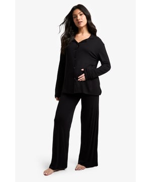 Soft jersey fabric for ultimate comfort
        Button-down front for easy nursing access
        Long sleeves for added warmth
        Wide-leg trousers for unrestricted movement
        Versatile maternity design to accommodate growing bump
    
    Embrace the journey of motherhood in style and comfort with this chic maternity pyjama set from Boohoo. The soft jersey fabric gently drapes over your changing silhouette, providing a cosy sanctuary for restful nights. The button-down top offers convenient access for night-time feeds, while the wide-leg trousers ensure unrestricted movement as you lounge or sleep. Perfect for those seeking a blend of functionality and fashion, this set can take you from relaxed evenings at home to lazy weekend mornings with ease. Layer with a soft dressing gown for added warmth, or pair the top with your favourite maternity leggings for a casual daytime look. This versatile set grows with you, offering comfort throughout your pregnancy and beyond.