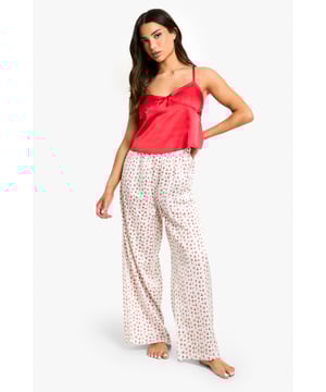 Charming cherry print pyjama set
        Satin-like camisole top with delicate ruffle trim
        Wide-leg trousers for ultimate comfort
        Adjustable spaghetti straps for a perfect fit
        Petite sizing for a tailored silhouette
    
    Indulge in sweet dreams with this adorable cherry print pyjama set, designed exclusively for our petite fashionistas. The satin-like camisole top features a flattering V-neckline adorned with a dainty ruffle trim, adding a touch of feminine charm to your nighttime ensemble. The wide-leg trousers offer unrestricted movement and breathability, ensuring a restful night's sleep. Adjustable spaghetti straps allow for a customised fit, while the petite sizing ensures a flattering silhouette without overwhelming your frame. Perfect for lounging at home or hosting a stylish sleepover with your besties, this pyjama set combines comfort with on-trend appeal. Pair with fluffy slippers and a cosy dressing gown for the ultimate relaxation experience.
