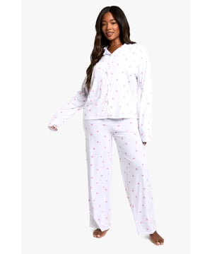 Charming bow print pyjama set
        Soft jersey fabric for ultimate comfort
        Long-sleeved button-up top with collar
        Relaxed fit trousers with wide legs
        Versatile two-piece design for mix-and-match options
    
    Indulge in sweet dreams with this delightful plus-size pyjama set from Boohoo. The charming bow print adds a touch of whimsy to your nighttime routine, while the soft jersey fabric ensures a cosy night's sleep. The long-sleeved top features a classic collar and button-up front, perfect for those chilly evenings. Pair it with the relaxed-fit trousers for a complete look, or mix and match with other nightwear pieces for versatile styling. Whether you're having a lazy Sunday morning or settling in for a night of binge-watching your favourite series, this pyjama set offers both comfort and style. It's the ideal choice for the fashion-forward woman who wants to look fabulous even when she's winding down for the day.