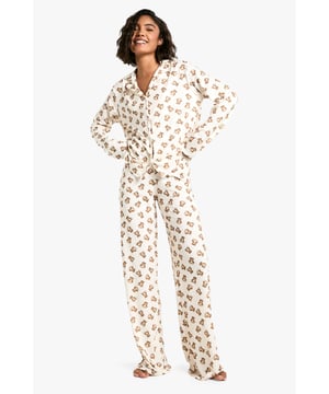 Charming bear print pyjama set
        Long-sleeved button-up top with notched collar
        Matching full-length trousers
        Soft jersey fabric for ultimate comfort
        Designed for tall frames
    
    Drift off to dreamland in style with this adorable bear print pyjama set from Boohoo. Perfect for those cosy nights in, this set combines comfort and charm effortlessly. The long-sleeved top features a classic button-up front and notched collar, while the full-length trousers ensure you stay snug from top to toe. Crafted from soft jersey fabric, it's designed to keep you comfortable throughout the night. The playful bear print adds a touch of whimsy to your nighttime routine, making bedtime something to look forward to. Ideal for lounging, late-night Netflix binges, or lazy weekend mornings, this pyjama set is versatile enough for year-round wear. For a complete nighttime ensemble, pair with fluffy slippers and a warm dressing gown for those chilly evenings. Whether you're treating yourself or looking for the perfect gift, this pyjama set is sure to delight any fashion-forward sleepyhead.