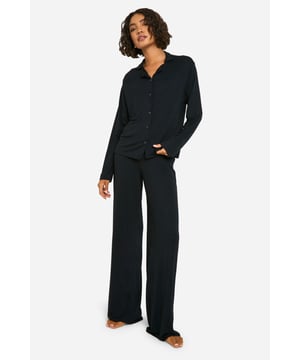 Tall-fit pyjama set for extra comfort and coverage
        Soft jersey fabric for a cosy night's sleep
        Button-up shirt with classic collar for a smart look
        Wide-leg trousers for unrestricted movement
        Long sleeves provide warmth on cooler nights
    
    Indulge in luxurious comfort with this tall-fit pyjama set, perfect for those who desire extra length and coverage. The soft jersey fabric drapes beautifully, ensuring a restful night's sleep. The button-up shirt with its classic collar adds a touch of sophistication to your nightwear, while the wide-leg trousers offer freedom of movement as you lounge or slumber. Ideal for year-round wear, the long sleeves provide warmth during chilly evenings, yet the breathable fabric keeps you comfortable throughout the night. Whether you're enjoying a lazy Sunday morning or settling in for a cosy night, this versatile set is your go-to for stylish relaxation. Pair with fluffy slippers and a warm dressing gown for the ultimate loungewear ensemble.