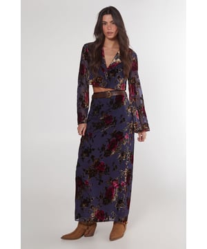 Striking floral devore pattern
        Maxi length for dramatic flair
        High-waisted design
        Side slit for ease of movement
        Coordinating crop top with bell sleeves
    
    Make a statement in this eye-catching floral devore maxi skirt from Nasty Gal. The intricate pattern adds depth and texture, while the maxi length creates a graceful silhouette. Perfect for daytime events, this skirt can be styled for various casual occasions. Pair it with the matching crop top as shown for a coordinated look, or mix it up with a plain fitted tee for a more relaxed vibe. The high-waisted design flatters the figure, while the side slit allows for comfortable movement. Complete the ensemble with ankle boots for a festival-ready outfit, or opt for flat sandals for a laid-back garden party. This versatile piece transitions effortlessly from family gatherings to casual brunches with friends, embodying the perfect blend of boho chic and contemporary style.