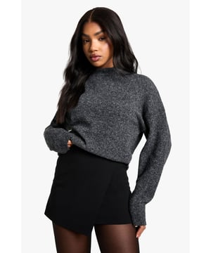 Wrap-style mini skirt design for a flattering silhouette
        Textured crepe fabric adds visual interest
        High-waisted fit accentuates the waistline
        Versatile black hue for easy styling
        Short length perfect for showcasing legs
    
    This wrap-style mini skirt from Boohoo is a versatile piece that can effortlessly transition from day to night. The textured crepe fabric adds a touch of sophistication, while the high-waisted fit creates a flattering silhouette. Style it with a cosy jumper and ankle boots for a chic daytime look, or pair it with a silky camisole and strappy heels for an evening out. The skirt's adaptable nature makes it suitable for various casual occasions, from brunches with friends to family gatherings. For a trendy ensemble, layer it with sheer tights and complete the look with chunky trainers and an oversized coat, as seen on the model. This mini skirt is a wardrobe essential that offers endless styling possibilities for the fashion-forward woman in her early to mid-20s who values both style and versatility.
