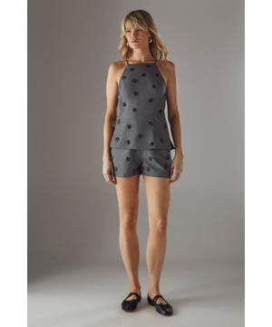 Sophisticated tailored shorts featuring delicate embellishment throughout for a distinctive look
        High-waisted design with a clean, streamlined silhouette for a flattering fit
        Subtle back pockets maintain the sleek aesthetic while offering practicality
        Versatile mid-thigh length perfect for both day and evening occasions
        Slight stretch in the fabric ensures comfort without compromising on structure
    
    These embellished tailored shorts from Warehouse showcase refined craftsmanship with their structured silhouette and eye-catching embellishments. The high-waisted design creates a leg-lengthening effect whilst the tailored cut offers a sophisticated edge to your going-out wardrobe. Style with a matching embellished top as shown for a coordinated set that commands attention, or break up the look with a crisp white blouse for cocktail events. For evening soires, pair with strappy heels and statement jewellery to amplify the glamour. When the temperature drops, layer with a cropped blazer to maintain the polished aesthetic. These shorts transition seamlessly from sunset drinks to late-night dancing, making them a versatile addition to your night-out collection.
