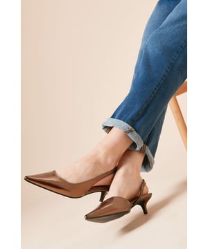 Elegant pointed toe design creates a flattering silhouette for your feet
        Slingback strap with elasticated insert for comfortable, secure fit
        Modest kitten heel measuring between 2.5-4.5cm offers perfect balance of style and comfort
        Faux leather finish provides a sophisticated look that's easy to maintain
        Versatile court shoe shape suitable for both casual and smart-casual occasions
    
    The Odessa slingback courts from Dorothy Perkins offer the perfect blend of comfort and style for the modern woman. The pointed toe and delicate kitten heel create a feminine silhouette without sacrificing wearability, making these shoes ideal for all-day wear. Style them with rolled-up jeans as shown for a casual weekend brunch with friends, or pair with cropped trousers and a blouse for family gatherings. The neutral tone makes these courts incredibly versatile, working seamlessly with printed dresses or tailored separates. The slingback design adds a contemporary touch to this classic silhouette, whilst providing breathability during warmer months. These shoes strike the perfect balance between practical daywear and stylish finishing touch - a true wardrobe essential that will carry you through multiple seasons with ease.
