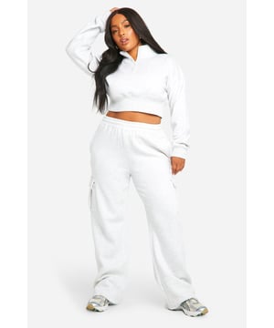 Cosy fleece-back fabric for ultimate comfort
        Cropped sweatshirt with ribbed collar and cuffs
        Straight-leg trousers with wrap-style waistband
        Convenient side pockets on trousers
        Versatile two-piece set for effortless styling
    
    Embrace laid-back chic with this Plus Sweatshirt and Straight Leg Trouser set from Boohoo. The cropped sweatshirt offers a trendy silhouette, while the straight-leg trousers with a unique wrap-style waistband add a contemporary twist to your casual wardrobe. Perfect for those lazy Sundays or running errands in style, this set is a must-have for the fashion-forward woman who values both comfort and trend-setting looks. Style it with chunky trainers and a crossbody bag for a cool, off-duty vibe, or dress it up with statement jewellery and sleek boots for a casual night out with friends. The versatility of this set makes it an ideal choice for various casual occasions, from family gatherings to weekend brunches, ensuring you look effortlessly stylish without compromising on comfort.