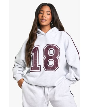 Oversized fit for ultimate comfort and style
        Bold '18' graphic print for a sporty, collegiate look
        Hooded design with spacious hood for added warmth
        Ribbed cuffs and hem for a snug fit
        Contrasting stripe detail along sleeves for visual interest
    
    Make a statement in this eye-catching oversized hoodie from Boohoo. Perfect for those who love to embrace casual chic, this piece combines comfort with on-trend style. The bold '18' graphic print adds a sporty, collegiate vibe that's sure to turn heads. Pair it with wide-leg joggers and chunky trainers for a laid-back weekend look, or dress it up with leather-look leggings and ankle boots for a night out with friends. The versatile design makes it ideal for various casual occasions, from lazy Sundays at home to casual meetups in the city. The cotton-blend fabric ensures breathability and softness, while the oversized fit allows for easy layering during cooler months. Whether you're running errands or meeting mates for coffee, this hoodie is your go-to for effortless style with a touch of urban cool.