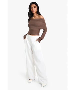 Straight leg trousers with distinctive waistband detail for a flattering silhouette
        Wide-leg design offering effortless movement and contemporary style
        Practical side pockets for convenience and functionality
        Smooth woven fabric with slight stretch for all-day comfort
        High-rise fit that pairs perfectly with cropped tops for night-out styling
    
    These statement trousers showcase a sophisticated waistband detail that creates a polished, put-together look for your evening adventures. The straight, wide-leg cut creates a dramatic silhouette that flows beautifully as you move, making them ideal for dancing the night away. Style with an off-shoulder top as shown for a balanced proportion that highlights the waistband feature. For a complete going-out ensemble, add pointed heels and a clutch bag for a look that transitions seamlessly from dinner to drinks. These versatile trousers work brilliantly for bar-hopping with friends or more upscale evening venues - simply adjust your accessories to suit the occasion. The clean lines and contemporary shape make these a wardrobe essential that will carry you through countless nights out with effortless style.
