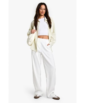 Designed specifically for taller frames with a flattering straight-leg silhouette
        Sleek waistband detail for a smooth, comfortable fit
        Practical side pockets for everyday essentials
        Versatile woven fabric with slight stretch for all-day comfort
        Wide-leg design creates a contemporary, fashion-forward look
    
    These sophisticated straight-leg trousers are the ultimate wardrobe essential for the fashion-forward woman. The clean lines and contemporary silhouette make them perfect for transitioning from day to night with effortless style. As seen on our model, pair with a simple crop top for a balanced look that showcases the high-waisted design, or add a structured blazer for more formal settings. The wide-leg cut creates a striking silhouette that works brilliantly with both trainers for casual daytime outings and heels for evening affairs. These trousers truly shine for going out occasions - whether you're heading to a trendy bar with friends or dancing the night away at a club. The slight stretch in the fabric ensures you'll remain comfortable whilst looking utterly chic throughout your evening adventures.