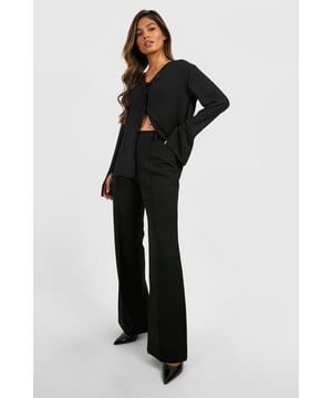 Flared leg design for a dramatic silhouette
        High-waisted fit accentuates the waistline
        Tailored construction for a polished look
        Stretchy bi-stretch fabric for comfort and movement
        Versatile style suitable for various occasions
    
    Make a statement with these eye-catching fit & flare tailored trousers from Boohoo. Perfect for the fashion-forward woman who loves to stand out, these trousers combine sophistication with a touch of drama. The high-waisted design elongates your legs, while the flared silhouette adds a bold, retro-inspired flair to your ensemble. Pair them with a cropped blazer and pointed-toe heels for a chic night out look, or dress them down with a fitted turtleneck and ankle boots for a stylish daytime outfit. The bi-stretch fabric ensures all-day comfort, allowing you to move with ease whether you're dancing the night away or navigating a busy day in the city. These trousers are a versatile addition to your wardrobe, easily transitioning from office to evening drinks with a simple change of accessories.