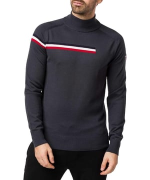50% Virgin Wool 50% Acrylic. The timeless turtleneck sweater from the sport chic collection. A stand-up collar provides unparalleled warmth and comfort, this men's pullover is the companion for a day on the court or on the town. The iconic tricolor stripe that is cut in the three quarters of the jersey to symbolize the exit to the track pays homage to the story of the brand