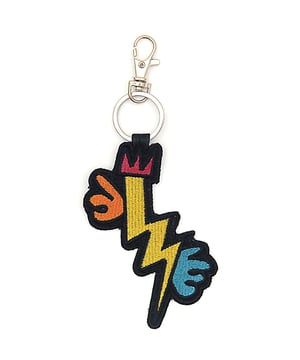 Synthetic. With a keychain in pop-art colours and enigmatic patterns, you can enjoy the style of Jean-Charles de Castelbajac, the driving force behind French fashion, both on and off the ski slopes. On the back side there is an embroidered faux leather insert