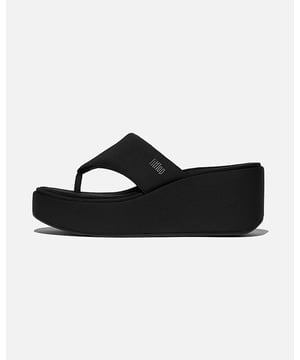 This trend-forward toe-post sandal is irresistible – think clean lines, a classic high-wedge sole and fun 90s vibe. Lightly padded. Wear-with-anything. Crafted in soft neoprene-style fabric, including wrapped around the sole. A 3D-print logo adds subtle branding. On our CushX™ midsole, biomechanist-designed for a sneaker feel in heeled styles (you can walk all day in these).

Ergonomically engineered to help optimize your body's alignment, natural movement & energy
CushX midsole has soft EVA cushioning inside a firmer EVA shell for stability, with heel-to-forefoot angle optimizing alignment & comfort in high heels
Anatomically contoured footbed diffuses pressure & gives natural arch support
Grip suited to everyday use/road tread
Heel height – 76.1mm
Impact pillow at forefoot for extra cushioning



Upper Material:FabricLining Material:Nylon Upper Microfibre FootbedFastening:Slip-OnOutsole:Slip-Resistant RubberTechnology:CushX
JF8