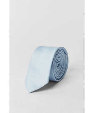 Textured woven fabric with subtle grid pattern for added visual interest
        Slim design with modern width for a contemporary silhouette
        Versatile dusty blue tone that complements various shirt colours
        Carefully finished pointed tip for a classic look
        One size design suitable for standard collar shirts
    
    This textured tie brings refined sophistication to your formal wardrobe. The subtle grid pattern adds depth and character without overwhelming your ensemble, making it perfect for those who appreciate understated elegance. Pair with a crisp white shirt as shown for boardroom meetings and important presentations, or match with light blue or grey shirts for a coordinated look. The tie works brilliantly with navy or grey suits for traditional office attire, while also complementing more casual blazer and trouser combinations for smart-casual events. Whether you're heading to an important client meeting, attending a wedding, or simply want to sharpen up your pub lunch outfit, this versatile accessory strikes the perfect balance between classic style and contemporary appeal - an essential addition to any gentleman's collection.
