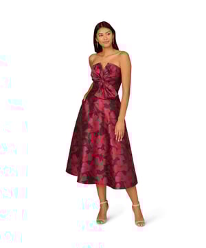 Make a stunning entrance in this strapless midi dress. This cocktail dress features a bow-trimmed bodice, a strapless neckline with notched cutout, and a full midi skirt with pockets. Designed with floral jacquard fabric from China, this fit and flare dress is a classic look that has been elevated with modern details. A hidden zipper back closure completes this floral party dress. Accessorized with heels and your favourite clutch, this strapless party dress is bound to shine for years to come.