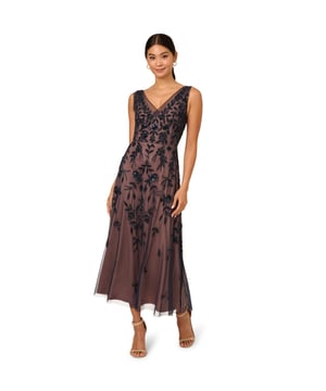 The delicate mesh overlay on this womens midi length sleeveless dress is finished with sparkling floral beading over the bodice and trailing down the skirt. Tailored seams and a back zipper create a fitted bodice cut flowing into a soft A-line skirt with a midi length hem. This gorgeous design evokes classic romance for a timeless dressy look.