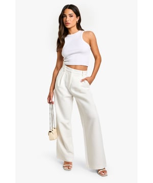 Wide-leg design for a relaxed and comfortable fit
        High-waisted silhouette to elongate the legs
        Side pockets for practicality and style
        Versatile woven fabric suitable for various occasions
        Petite sizing for a perfect fit on smaller frames
    
    These essential wide-leg trousers are a must-have addition to your wardrobe, offering both style and comfort for the fashion-forward woman. The high-waisted design creates a flattering silhouette, while the relaxed wide-leg cut allows for easy movement and a trendy look. Perfect for casual outings or dressed up for more formal events, these trousers can be styled in numerous ways. Pair them with a fitted crop top and strappy sandals for a chic summer ensemble, or dress them up with a tucked-in blouse and heels for a sophisticated office look. The side pockets add a practical touch, making these trousers ideal for everyday wear. Whether you're heading to a family gathering or a casual lunch with friends, these versatile trousers will keep you looking effortlessly stylish and feeling confident throughout the day.