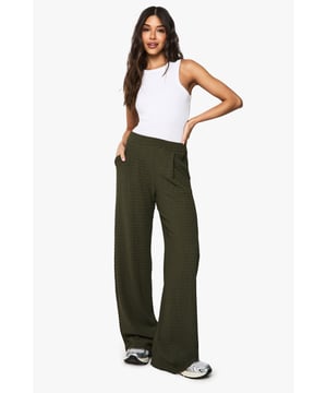 Textured fabric adds depth and visual interest
        Wide-leg silhouette for a relaxed, on-trend look
        High-rise waist for a flattering fit
        Side pockets for practicality
        Versatile design suitable for various casual occasions
    
    Make a bold statement with these eye-catching wide-leg trousers from Boohoo. The textured fabric adds a touch of sophistication to your casual wardrobe, whilst the relaxed silhouette ensures all-day comfort. Perfect for the fashion-forward woman who values both style and ease, these trousers can be dressed up or down with ease. Pair them with a fitted white vest top and trainers for a laid-back daytime look, or style with a cropped blouse and heeled sandals for evening drinks. The high-rise waist creates a sleek silhouette, while the side pockets add functionality to the design. Whether you're heading to a family gathering or meeting friends for brunch, these trousers will keep you looking effortlessly chic. Embrace the wide-leg trend and make these trousers your go-to for casual-cool outfits that radiate confidence and style.