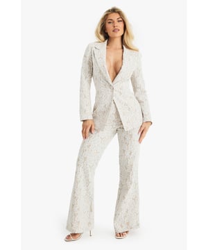 Exquisite lace flared trousers with matching blazer
        High-waisted design for a flattering silhouette
        Elegant woven crepe fabric with intricate lace pattern
        Flared leg cut for a dramatic, fashion-forward look
        Versatile two-piece set suitable for various formal occasions
    
    Make a lasting impression with these stunning lace flared trousers from Boohoo. Perfect for the fashion-forward woman who loves to stand out, these trousers offer a bold and sophisticated look for any special event. The high-waisted design accentuates your curves, while the flared leg creates a dramatic silhouette that's sure to turn heads. Pair with the matching blazer for a coordinated ensemble that exudes confidence and style. Ideal for weddings, formal parties, or glamorous nights out, these trousers can be dressed up or down to suit your needs. For a chic daytime look, style with a simple camisole and strappy heels. For evening events, amp up the glamour with statement jewellery and a sleek clutch. The versatility of this piece ensures it will become a go-to in your wardrobe for seasons to come.