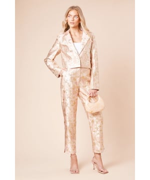 Elegant jacquard fabric with a lustrous finish and textured floral pattern
        Sophisticated tapered fit that narrows towards the ankle for a refined silhouette
        Practical side pockets for essential items
        Flattering high-waist design with a sleek waistband
        Ankle-length cut with subtle side slits for enhanced movement and style
    
    These Dorothy Perkins Tailored Jacquard Tapered Trousers offer the perfect balance of sophistication and contemporary style. The exquisite jacquard weave creates a textured finish that catches the light beautifully, making these trousers ideal for special occasions. Style with a crisp white blouse and strappy heels as shown for elegant wedding guest attire, or pair with a coordinating jacquard blazer for a striking head-to-toe look at formal events. The tapered silhouette creates a flattering shape that works wonderfully for race day ensembles or graduation ceremonies. For evening affairs, match with a simple camisole and statement jewellery to let the trousers take centre stage. These versatile occasion trousers transition seamlessly from day to night, offering endless styling possibilities for the fashion-conscious woman who appreciates refined elegance with a contemporary twist.