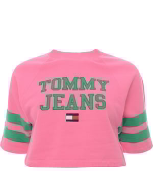 Main: 100% Cotton. The Tommy Jeans short sleeve sweatshirt in pink with green branding offers a striking contrast that's sure to stand out. This trendy piece combines the classic comfort of a sweatshirt with the coolness of short sleeves, perfect for those transitional seasons or a stylish layering option. The vibrant pink hue paired with the bold green logo creates a fresh and preppy look, embodying the spirit of the Tommy Hilfiger brand. Whether you're out for a casual day or looking to add a pop of color to your outfit, this sweatshirt is a versatile addition to any wardrobe.