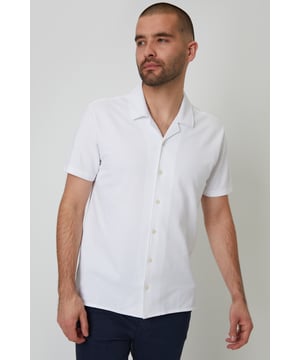 This lightweight pique shirt from Threadbare will have you ready for the summer months. Crafted with a from a soft cotton jersey pique, this shirt features a revere collar with single needle stitching and a button-through fastening. The short sleeves and side split vents offer comfort and breathability for warm days. Complete with a back yoke seam for added detail, this shirt is perfect for casual outings or beachside gatherings. Pair it with tailored shorts or lightweight trousers for a relaxed look that's ideal for sunny days and balmy evenings.