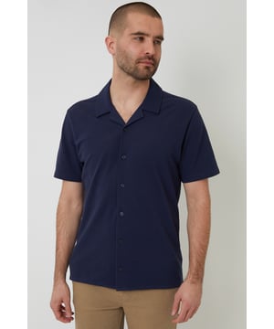 This lightweight pique shirt from Threadbare will have you ready for the summer months. Crafted with a from a soft cotton jersey pique, this shirt features a revere collar with single needle stitching and a button-through fastening. The short sleeves and side split vents offer comfort and breathability for warm days. Complete with a back yoke seam for added detail, this shirt is perfect for casual outings or beachside gatherings. Pair it with tailored shorts or lightweight trousers for a relaxed look that's ideal for sunny days and balmy evenings.