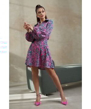 Helles A-Linien-Kleid aus bedrucktem, weichem Stoff. Ausgestelltes, locker sitzendes Produkt mit abnehmbarem Gürtel. Das Kleid ist mit einem Kragen und einem keilförmigen Ausschnitt verziert. Knielanges Modell mit langen, voluminösen Ärmeln mit Gummizug.