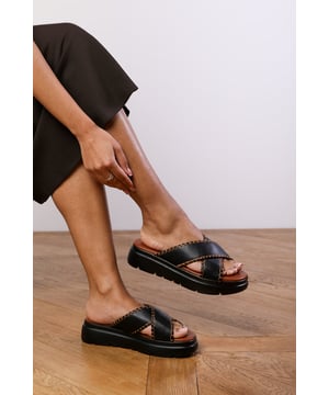 Step into effortless elegance with our Angela Chunky Cross-Strap Slide Sandal. Designed for both comfort and style, these sandals feature a unique cross-strap design with stitched detailing, making them a must-have addition to your footwear collection.