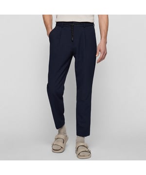 Hook eye and zip fastening.Elasticated drawstring waist.Slit side pockets.Slightly tapered cut.