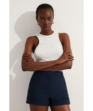 These tailored linen shorts from Karen Millen embody sophisticated summer style. The high-waisted design and tailored fit create a flattering silhouette, perfect for the fashion-forward woman who values both comfort and elegance. Style these shorts with a crisp sleeveless top and a slim belt for a polished daytime look. The breathable linen blend fabric makes these shorts ideal for warm weather gatherings, from casual brunches to family picnics. Pair with flat sandals and statement jewellery for a chic ensemble that transitions effortlessly from day to evening. The versatile length and classic design ensure these shorts will become a staple in your warm-weather wardrobe.    Tailored fit for a polished silhouette High-waisted design with a sleek waistband Linen-blend fabric for breathable comfort Side pockets for practicality Versatile 36cm length suitable for various occasions