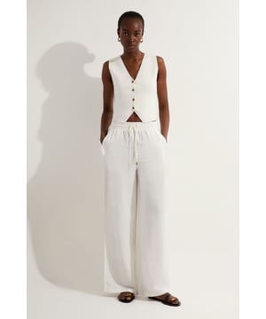 Welcome warmer weather in our linen trousers, made in lightweight fabric, with a drawstring waistband, and a minimal design perfect for styling all summer long. Style it simply with strappy sandals or heels for a look that will take you from summer wedding guest days to date nights to holiday evenings. Viscose Linen Tie Waist Woven Trouser High Quality Linen Fabric Flattering, Wide Leg Silhouette Comfortable, High Waistline Drawstring Waistline
