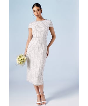 Exquisite pearl embellishments create intricate patterns
        Elegant column silhouette for a timeless bridal look
        Delicate cap sleeves offer graceful arm coverage
        Midi length with a sophisticated back slit for ease of movement
        Hand-stitched detailing showcases exceptional craftsmanship
    
    Make a stunning entrance on your special day with this captivating bridal dress from Coast. The column silhouette gracefully contours your figure, while the intricate pearl embellishments create a mesmerising effect that catches the light with every step. The cap sleeves add a touch of vintage-inspired charm, perfectly balancing the modern midi length. Style this gown with delicate strappy heels and a classic updo to showcase the beautiful neckline. For a coordinated bridal party look, consider pairing with bridesmaids in complementary pearl-accented dresses. This versatile piece transitions beautifully from ceremony to reception, ensuring you radiate elegance throughout your entire wedding day celebration.