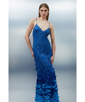 Make a captivating entrance at your next formal event in this exquisite maxi dress from Karen Millen. The intricate floral applique detailing creates a mesmerising visual effect, starting subtly at the bodice and intensifying towards the hem for a truly show-stopping look. The sleek V-neckline and spaghetti straps offer a graceful frame for your decolletage, while the woven fabric ensures a flattering fit that moves elegantly with every step. Perfect for weddings, galas, or black-tie affairs, this dress demands attention. Style it with strappy metallic heels and delicate drop earrings to complete your refined ensemble. For cooler evenings, drape a lightweight shawl over your shoulders for an added touch of sophistication.   Stunning floral applique detailing cascading down the dress Elegant V-neckline complemented by delicate spaghetti straps Figure-flattering woven fabric that drapes beautifully Maxi length design for a dramatic, floor-sweeping silhouette Gradient effect created by increasing density of applique towards the hem