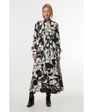 Experience elevated top options in our maxi dress, featuring a striking, monochromatic pattern and a tied neckline. Pair it with heeled boots or strappy heels for all eventualities. Printed Tie Neck Woven Maxi Dress Striking Marbled Pattern Unique, Tied High Neckline Comfortable, Straight Fit Long Balloon Sleeves Zip Back FasteningBrowse this seasons work dresses or discover the full range of workwear now.